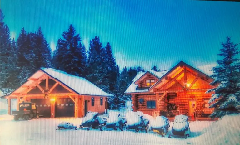 lodge with snowmobiles in front